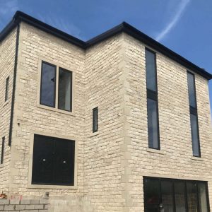 House built using tumbled walling stone with a clean finish.